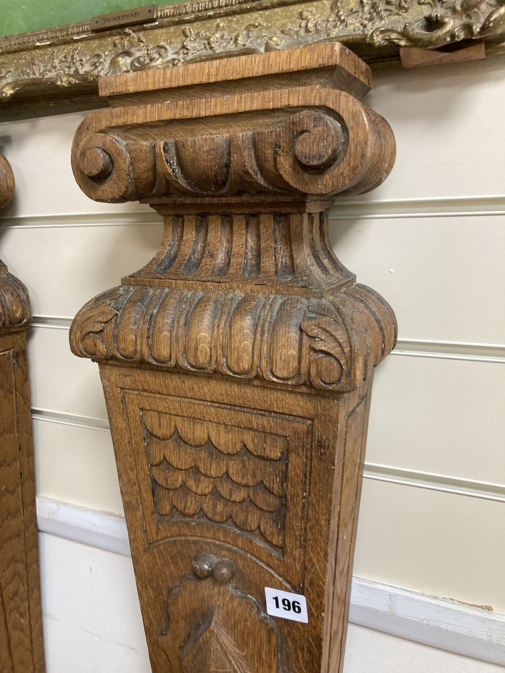 A pair of oak and iron wall sconces, height 88cm